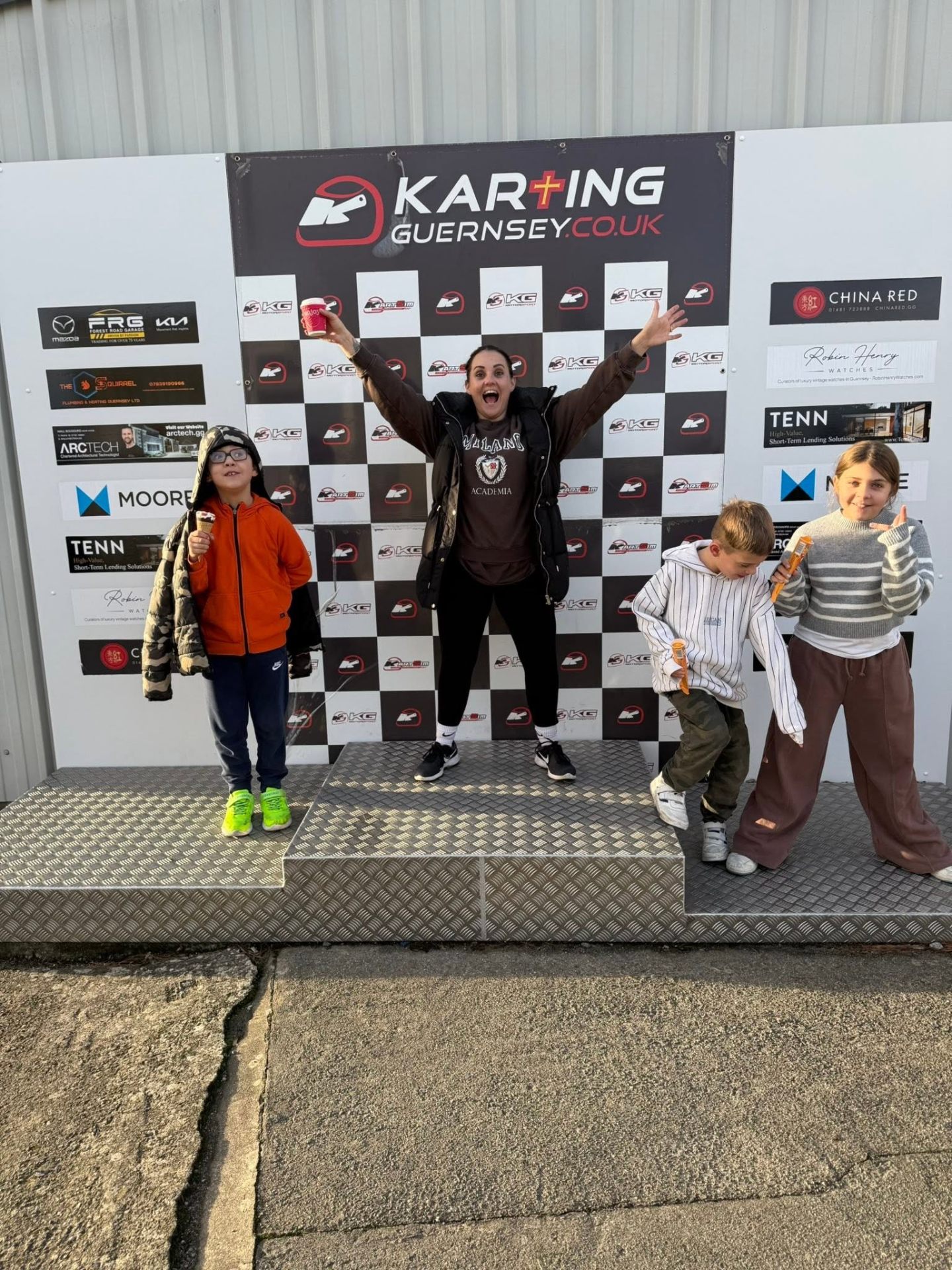 Steph celebrating on the Karting Guernsey podium with the kids